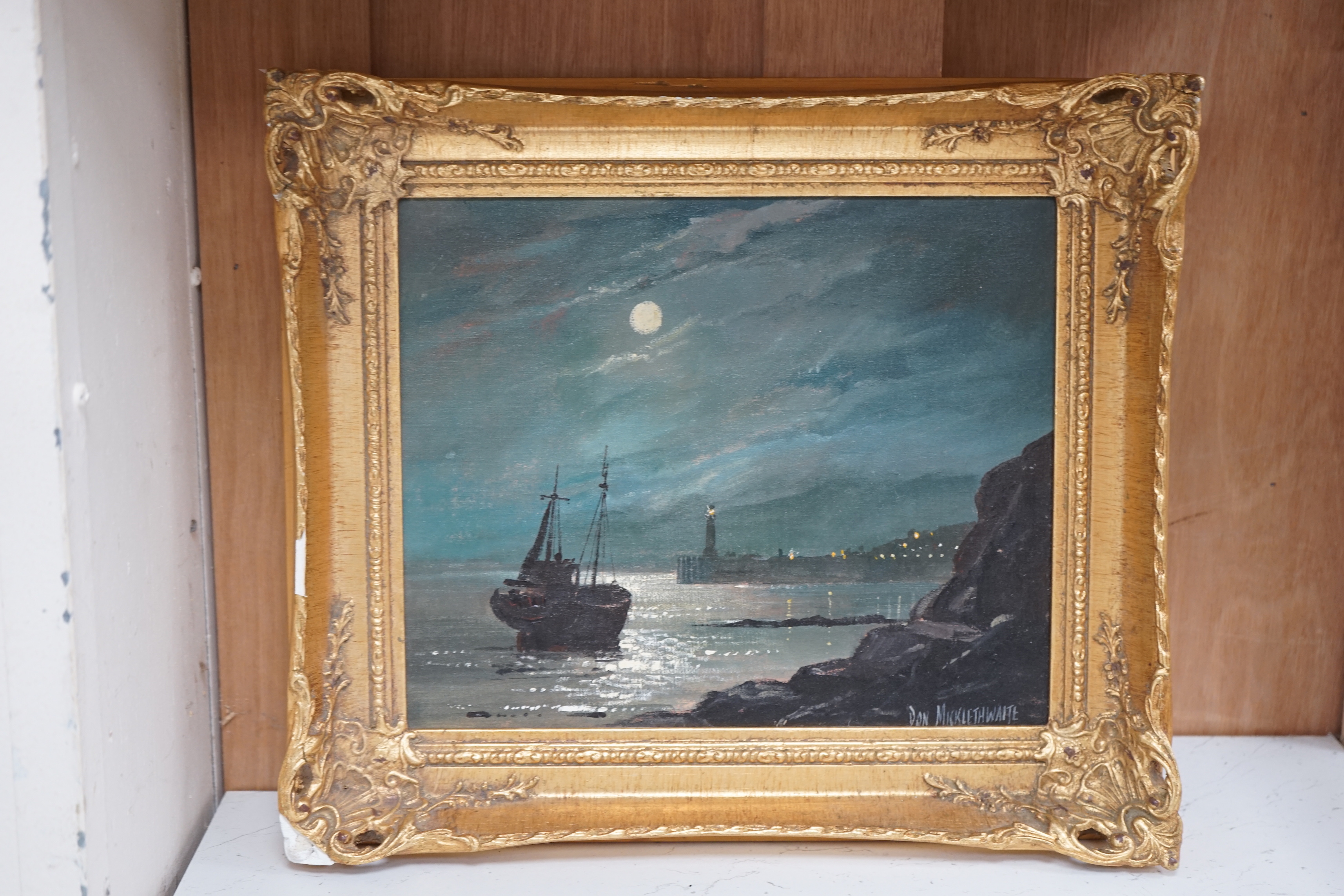 Don Micklethwaite (b. 1936), oil on canvas board, Moonlit coastal landscape with lighthouse, signed, 23 x 28cm